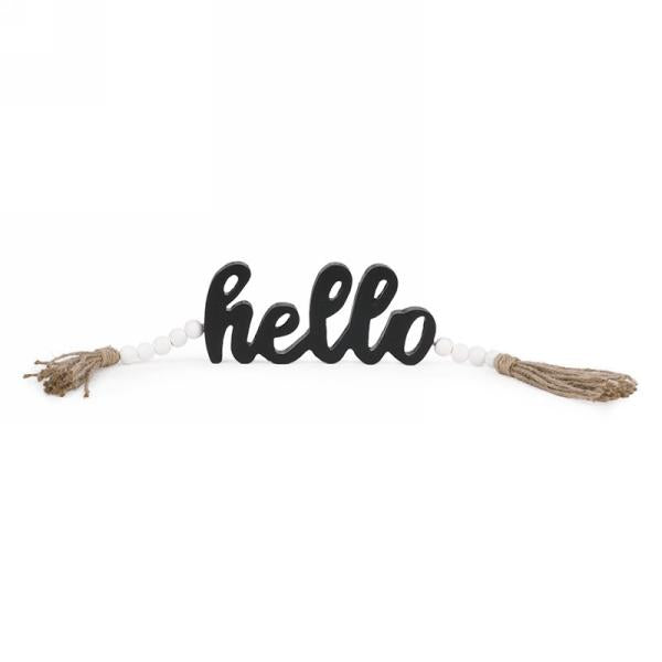 Black HELLO sign with tassel